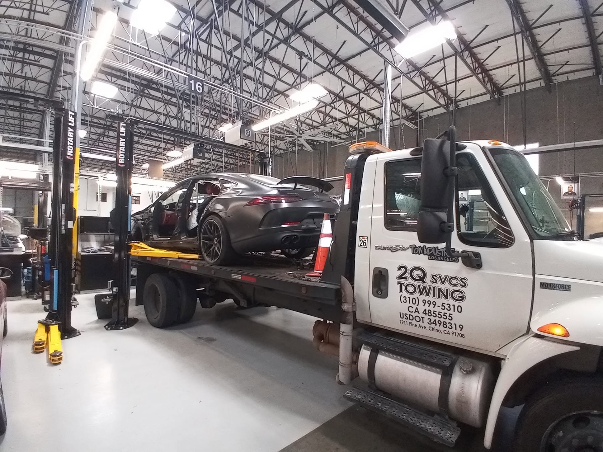 Mercedes-AMG GT unloaded inside a service shop by 2Q Svcs & Towing